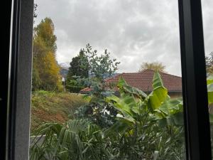 a window with a view of a house at Superbe appartement entre lac et montagne. in Veyrier-du-Lac