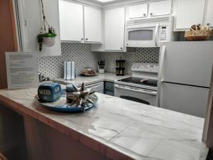 a kitchen with white cabinets and a counter top at Perfect Couples Retreat - close to all amenities in Hot Springs