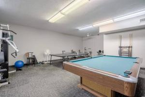 a pool table in a room with two tables at Perfect Couples Retreat - close to all amenities in Hot Springs