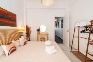 a bedroom with a bed with white towels on it at Spa Diamond, 71 sqm, private Whirlpool in Athens