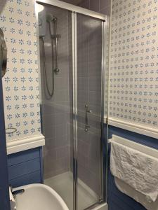 a bathroom with a shower with a toilet and a sink at Halfway House Inn in Kingsand