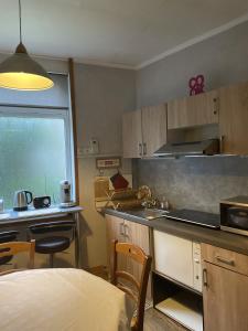 a kitchen with a table and a counter top at Appartement de charme in Bergues
