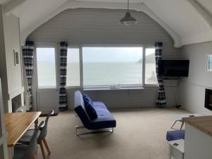 a living room with a couch and a large window at Halfway House Inn in Kingsand