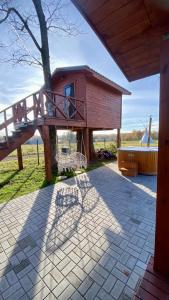 a house with a deck and a tree at Lake House in Anykščiai