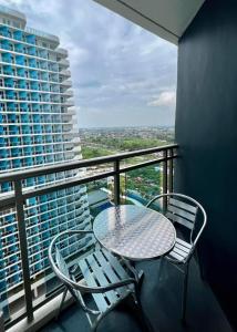 a table and chairs on a balcony with a view at Azure North San Fernando Pampanga in San Fernando
