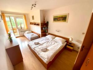 a small bedroom with a bed and a window at Apartmány Tatran Donovaly in Donovaly