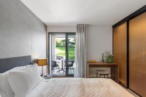 a bedroom with a bed and a table and a balcony at 3 VIE Restaurant & Rooms in Acquarossa +50 photos