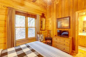 a bedroom with a bed and a tv and a window at Little Fox Den Ellijay Cabin Rental with Hot Tub! in Ellijay