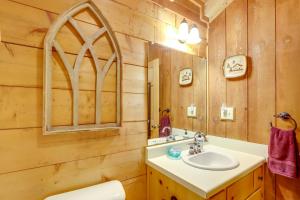 a bathroom with a sink and a mirror at Little Fox Den Ellijay Cabin Rental with Hot Tub! in Ellijay +18 photos