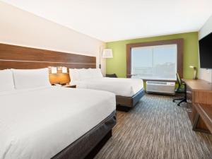 a hotel room with two beds and a desk at Holiday Inn Express & Suites Niceville - Eglin Area by IHG in Niceville