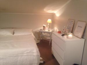 a bedroom with a bed and a night stand with a lamp at Hotel Santa Maria in Saint-Florent