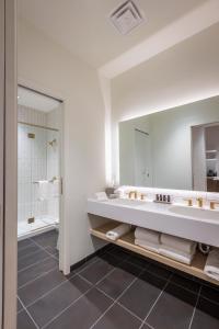 a bathroom with a large sink and a mirror at Hotel Covington Cincinnati Riverfront in Covington
