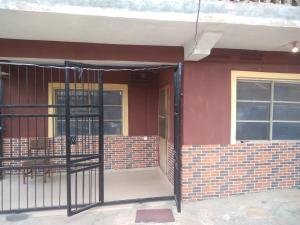 a red brick building with a gate in front of it at Two bedroom Home at Gbagi, New Ife Road, Ibadan @ Igbekele Oluwa House, 3 Zone A, Opeyemi Street, New Gbagi Market, New Ife Road, Gbagi, Ibadan, Oyo State in Ibadan