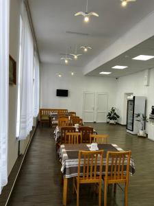 a dining room with wooden tables and chairs at Готель in Bila Tserkva