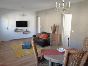 a living room with a couch and a table at Le JV 1 cayeux sur mer baie de somme 100m plage in Cayeux-sur-Mer