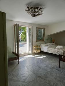 1 dormitorio con 1 cama y puerta corredera de cristal en b&b RetrO'Conero, en Castelfidardo