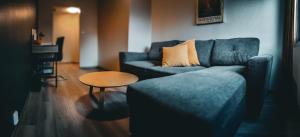 a living room with a couch and a table at Hotell Molde in Molde