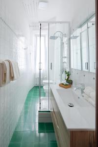 a white bathroom with a tub and a sink at [La Casa di Rinny Circo Massimo] in Rome