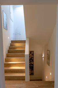 a staircase in a house with wooden floors at Casetta al centro in Trento