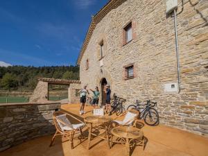 a group of people standing outside of a stone building at Mas el Coll in El Gurb