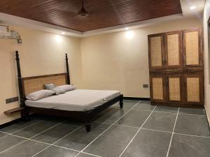 a bedroom with a bed in a room at Ooru homestay in Udupi