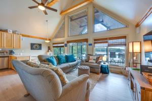 a living room with couches and a large window at Luxe Lake Sinclair Living Private Dock and Beach! in Resseaus Crossroads