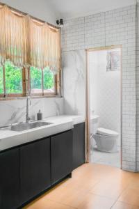 a bathroom with a sink and a toilet at Bali Invest Living in Canggu