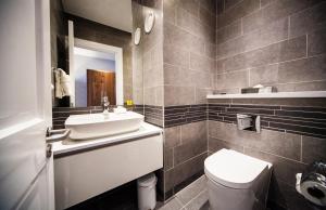 a bathroom with a sink and a toilet and a mirror at Crowne Plaza Leeds, an IHG Hotel in Leeds