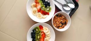 three plates of food with fruit and granola on a table at OSIMiRI ARENAL apartamento-Naturaleza-aventura-comodidad-Cine en casa in San Rafael