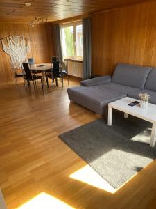 a living room with a couch and a table at Apartmenthaus Selbitz in Selbitz