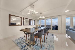 a dining room with a table and chairs at Luxury Beachfront Condo With Amazing Sunset Views in South Padre Island