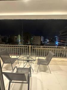 a group of chairs and a table on a balcony at cozy home near all services (21) in Rujm ash Sharāʼirah