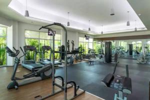 a gym with treadmills and elliptical machines at MAREAZUL Beachfront Apartment 2BR Private Pool Casa Áncora in Playa del Carmen