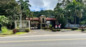 a house sitting on the side of a road at Spacious Penthouse with pool & Jungle Views in La Mona