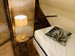 Habitación con cama con lámpara y silla en Mihr's rustplek in de Abdij van Bornem en Bornem