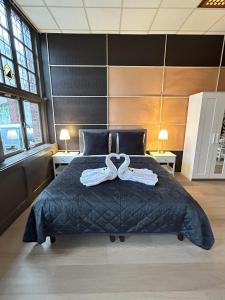 a bedroom with a large bed with two towels on it at Cozy Studio S2, City Centre Dordrecht in Dordrecht