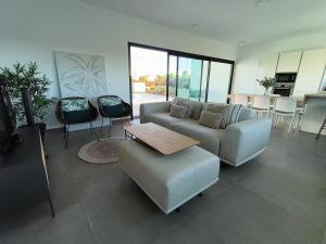 a living room with a couch and a table and chairs at Villa Montaña Colorada in Lajares