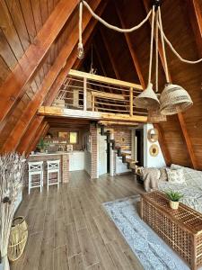 a living room with a kitchen and a loft at Zlatar Resort & SPA in Nova Varoš