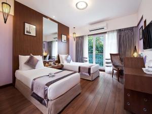 Postel nebo postele na pokoji v ubytování Grand Residency Hotel & Serviced Apartments