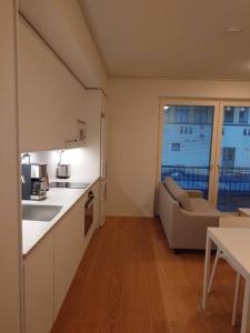 a kitchen with a couch and a table in a room at New AC Studio City Center. in Turku +2 photos