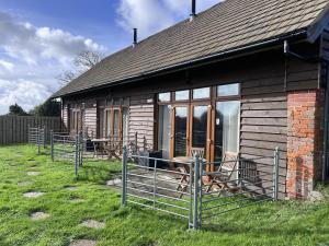 a house with chairs and a table in front of it at Bike Shed - Beautiful 1-Bed Cottage in Shorwell in Shorwell