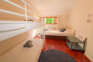 a small room with two bunk beds and a table at La Campa in Canfranc-Estación +25 photos
