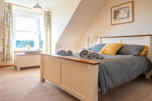 a bedroom with a bed with towels on it at Hillside Cottage in Aberdeen