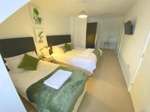 two beds in a small room with at The Woodcutter - Competitive rates Walsall in Walsall