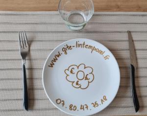 a plate with aimimitz littlefinger on it sitting on a table with at Gîte L'intemporel proche Lille de 2 à 11 personnes 
