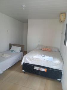 a bedroom with two beds in a room at Pousada da Rotatória in São Gonçalo do Amarante
