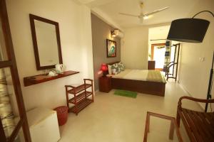 a bedroom with a bed and a mirror in a room at Temple Tree in Weligama