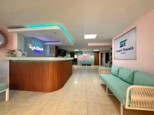 a lobby of a hospital with a bar and chairs at Taybo Beach By St Hoteles in Santa Marta