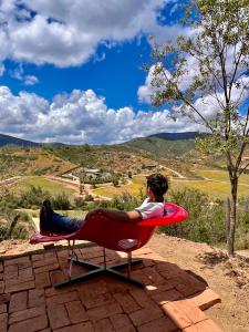 a man sitting in a chair with a view at Residencia Artistica CasaVino in Casablanca