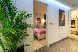 a bedroom with a bed and a potted plant at Apartments Lavander & Violet in Dubrovnik